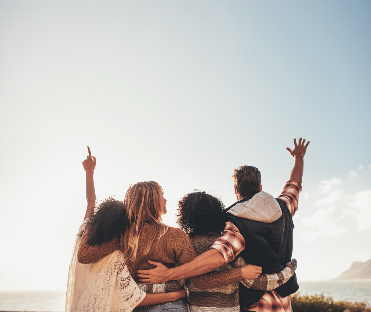 a group of people standing next to each other in the mountains